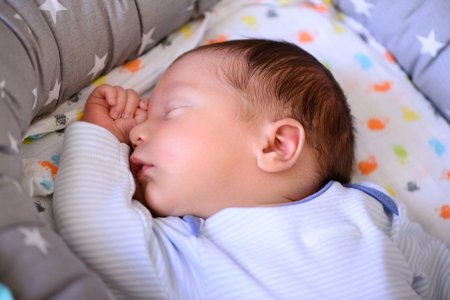 sleeping baby is monitored through a baby monitor