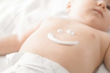 Baby met droge huid wordt verzorgt met babyzalf