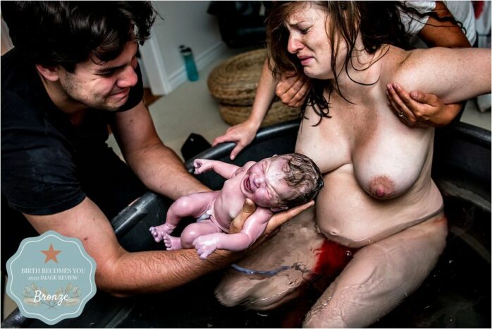 Vader en moeder zien geëmotioneerd hun baby voor de eerste keer