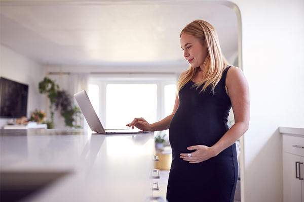 zwangere vrouw bekijkt adresverzoeker op haar laptop