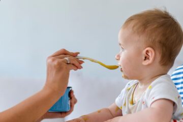 Een baby die babyvoeding krijgt zonder bestrijdingsmiddelen.