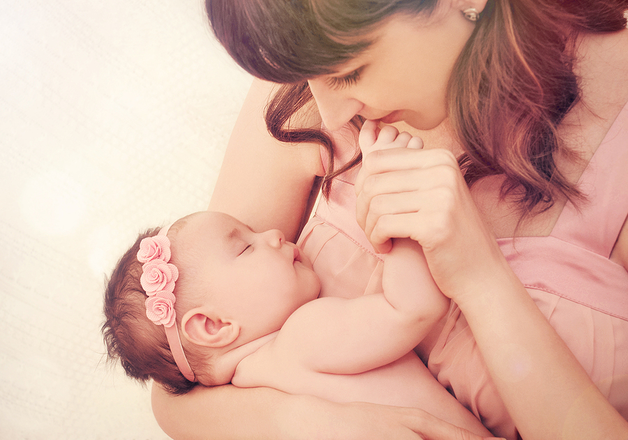 Mutter küsst Hand ihres Babys