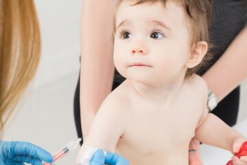 Baby bekommt eine Spritze in den Arm