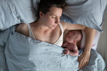Familienbett: Mutter schläft neben ihrem Baby im Bett
